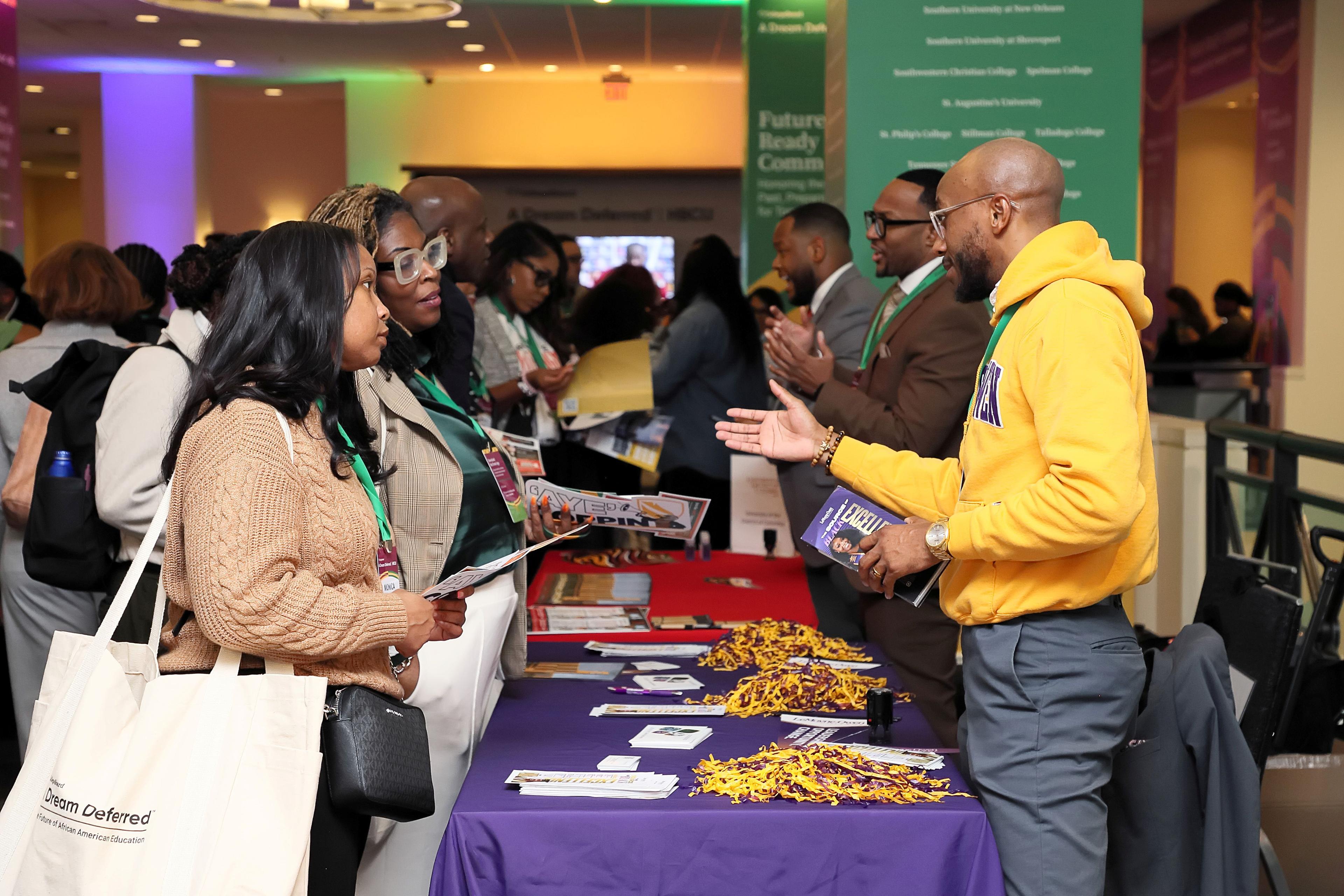 Attendees meeting at a college fair.